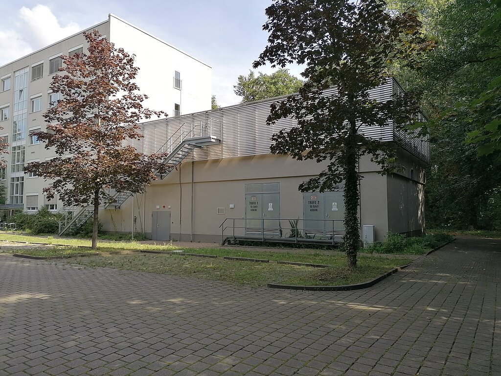 View of the transformer building, trees in front of it
