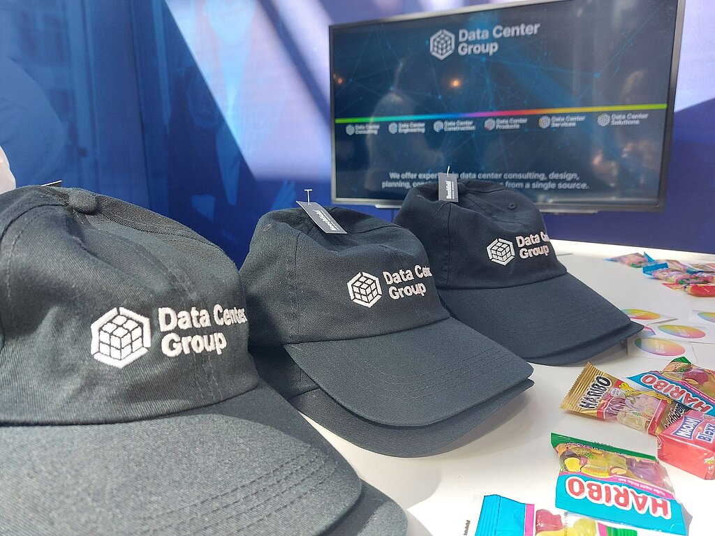 several caps with Data Center Group written on them, next to them gummy bears