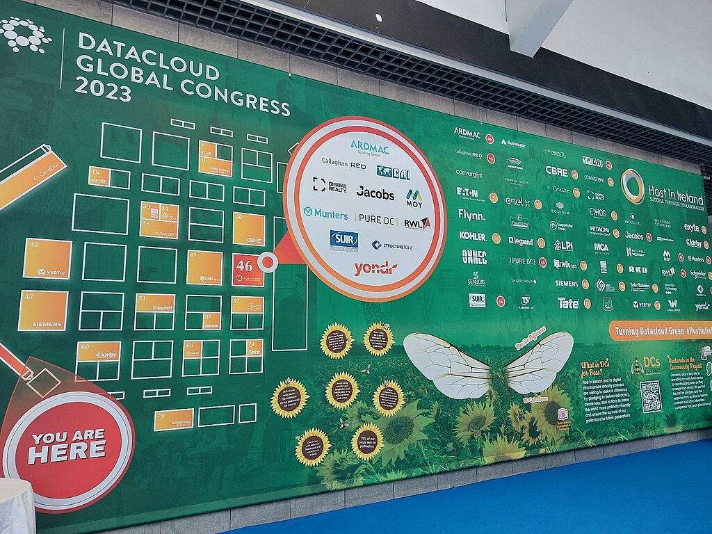 Promotional wall of the Data Cloud Congress in Monaco, held in green